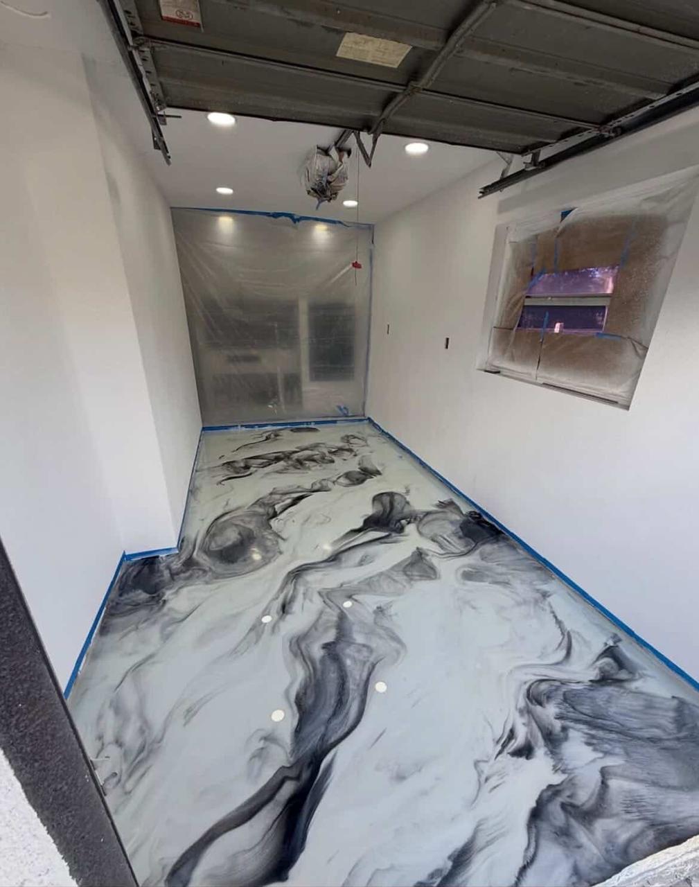 Black and white metallic epoxy floor in a workshop